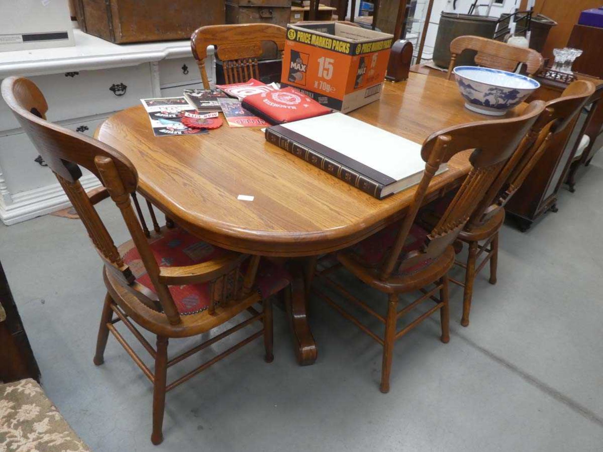 Oak extending dining table plus six stick back chairs