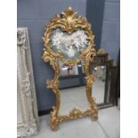 Mirror with ornate gilt frame and cherub panel