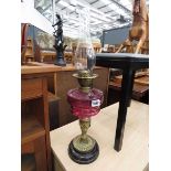 Brass and cranberry glass oil lamp