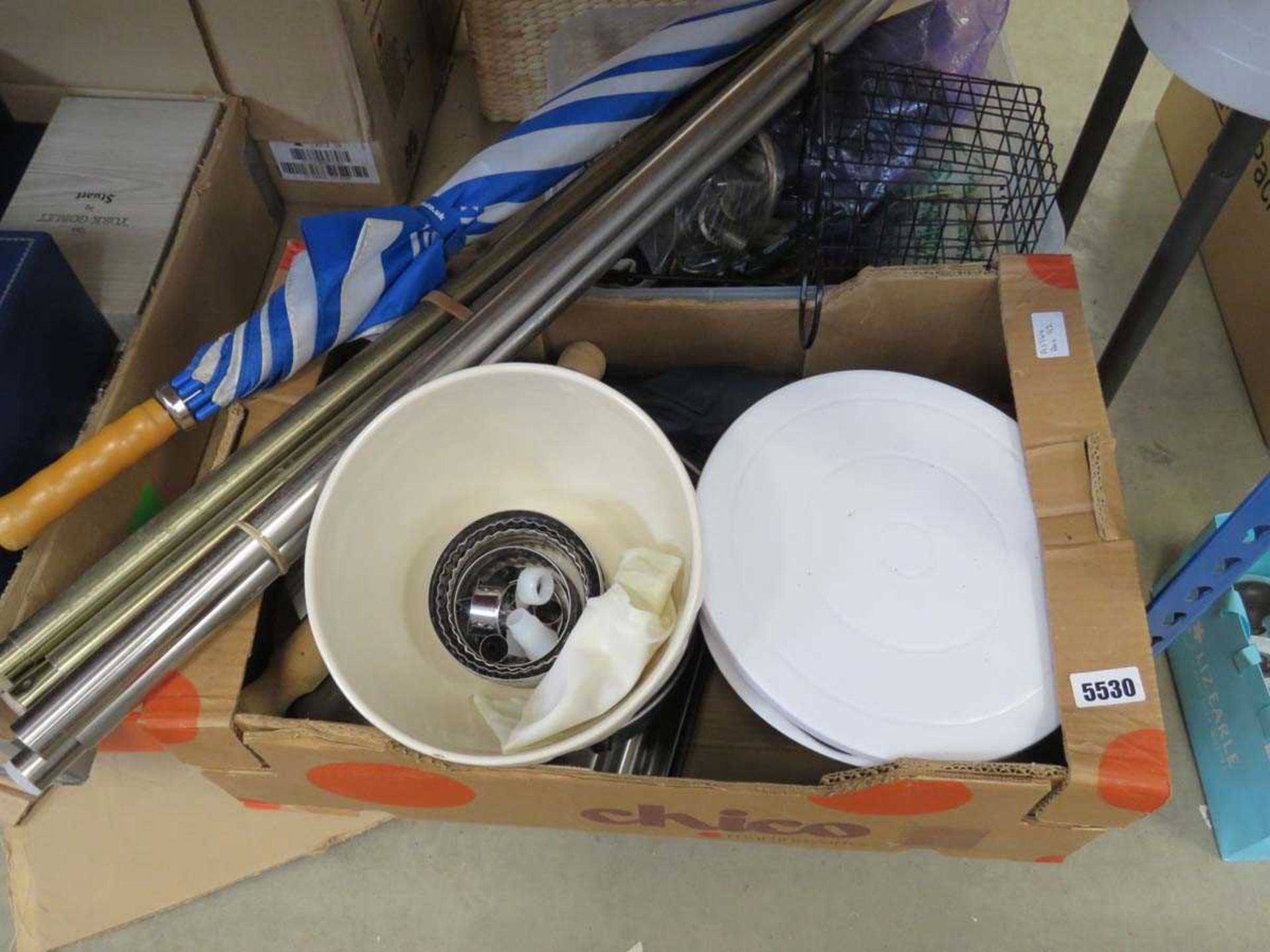 2 boxes containing mixing bowls, curtain rails, umbrella and other household goods