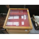 Table top display case with sloping surface