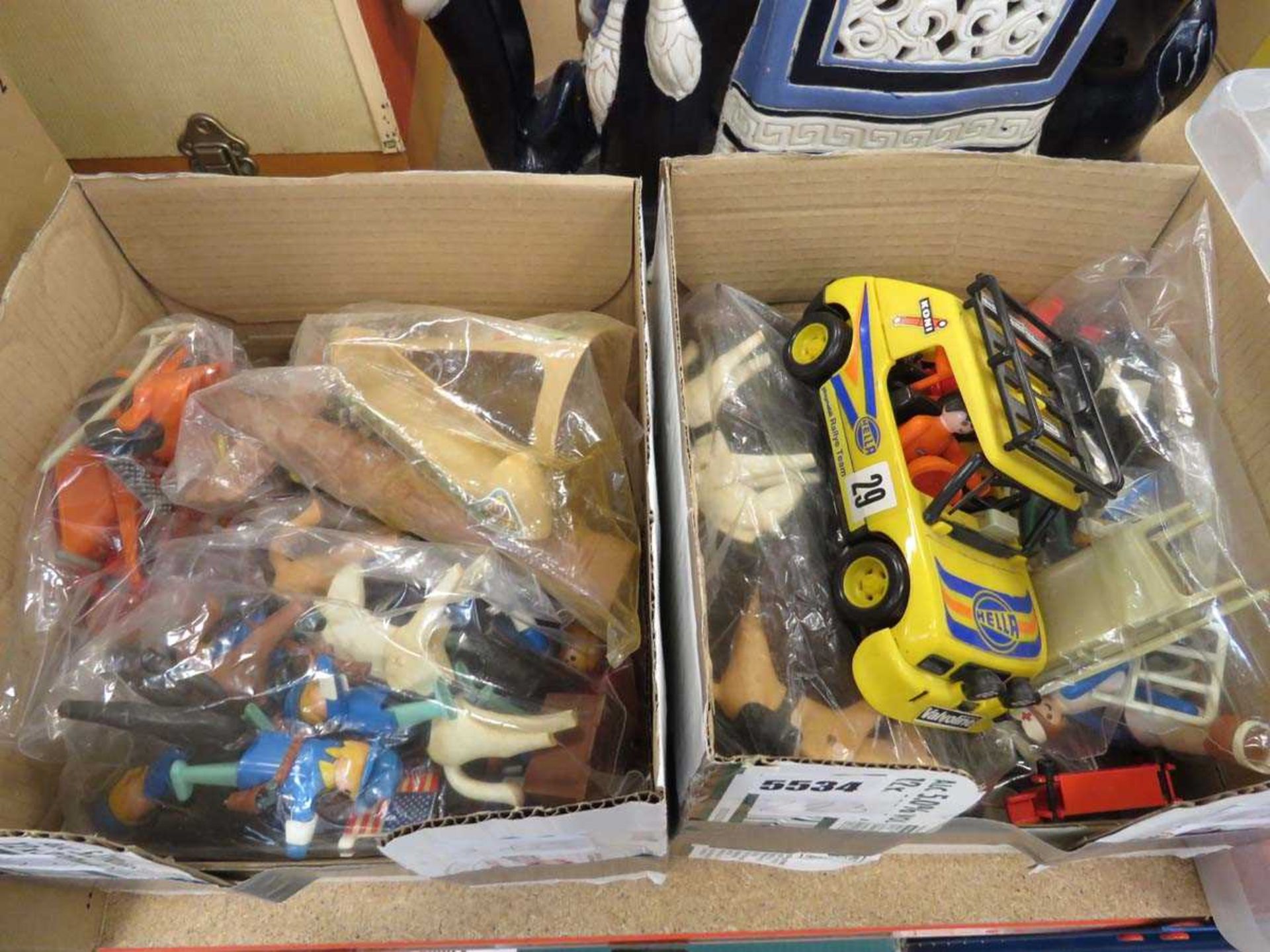 2 boxes containing plastic animals and other toys