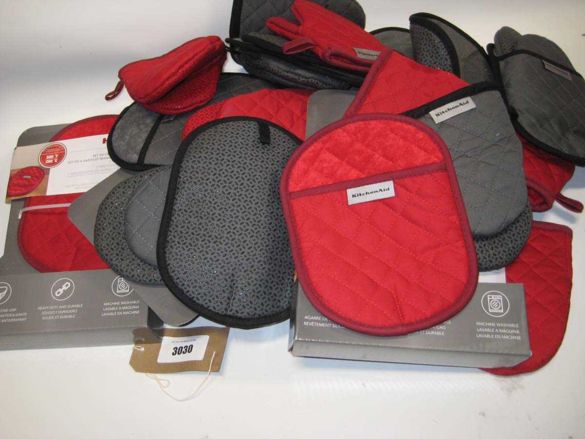 +VAT A bag containing Kitchen Aid Oven Gloves in Red & Grey