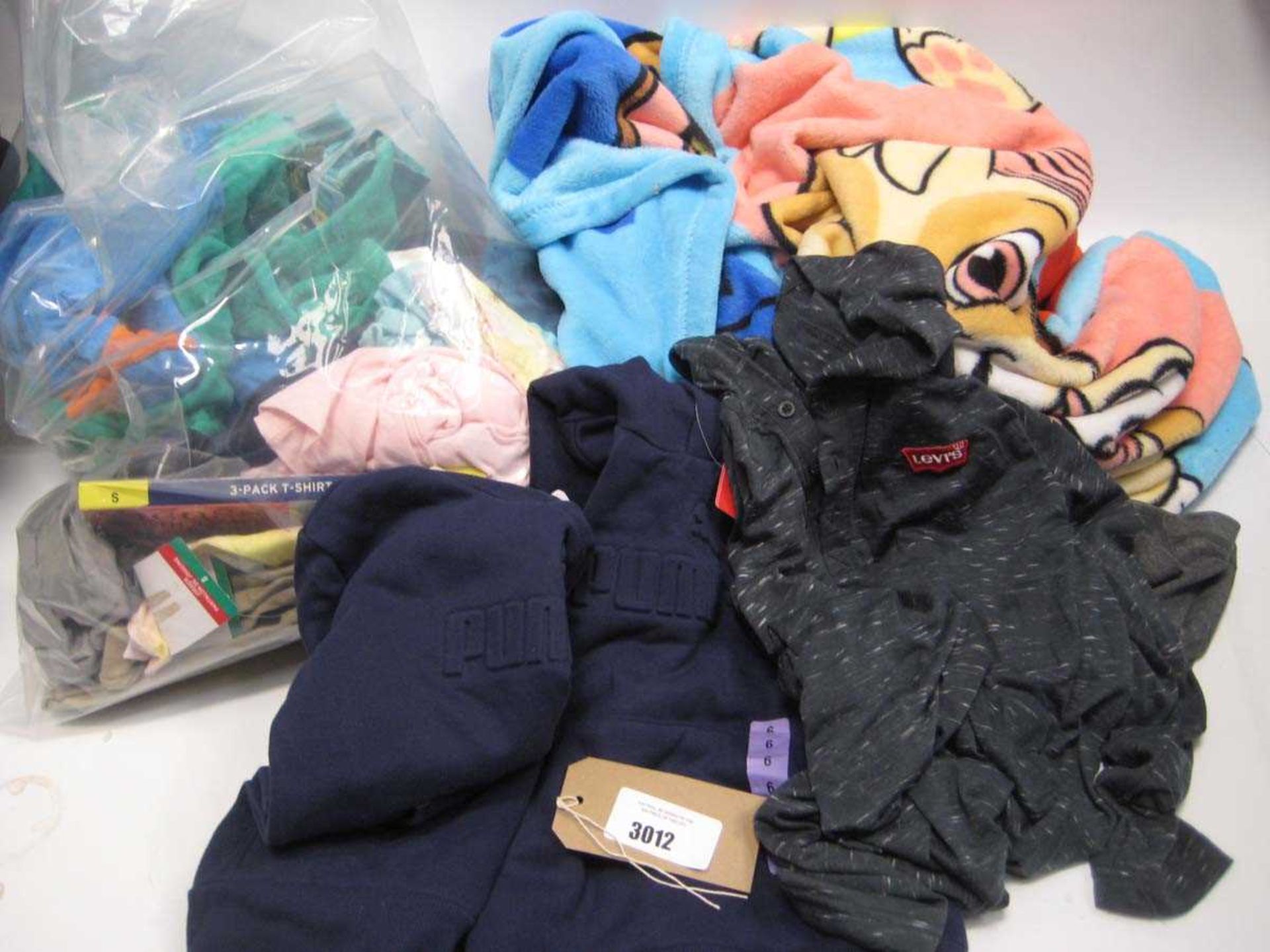 A bag containing Children's Clothing in various sizes and a Paw Patrol Throw, including Puma Hoodies