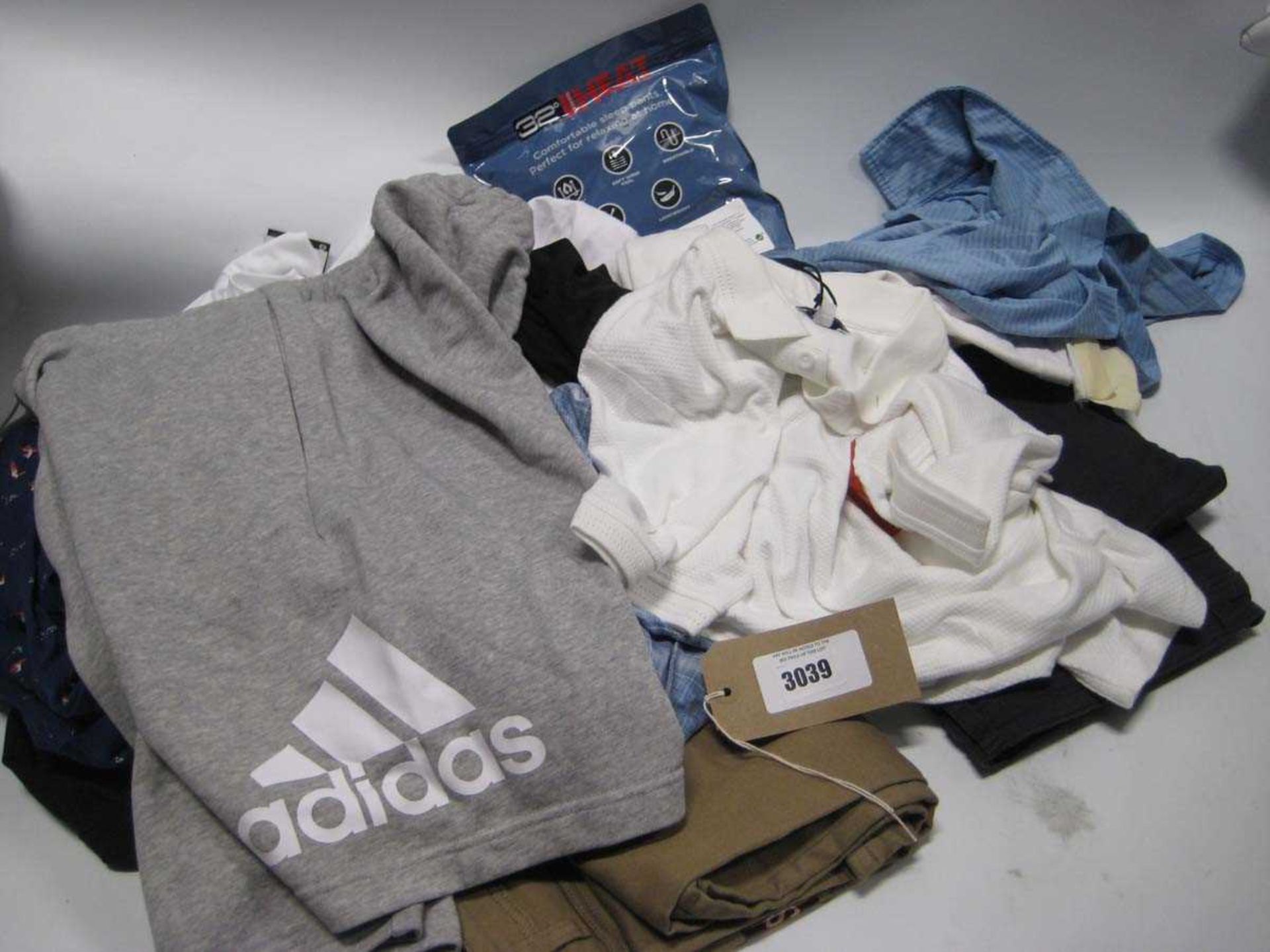 +VAT A bag containing Men's Clothing in various sizes, including Under Armour, Adidas