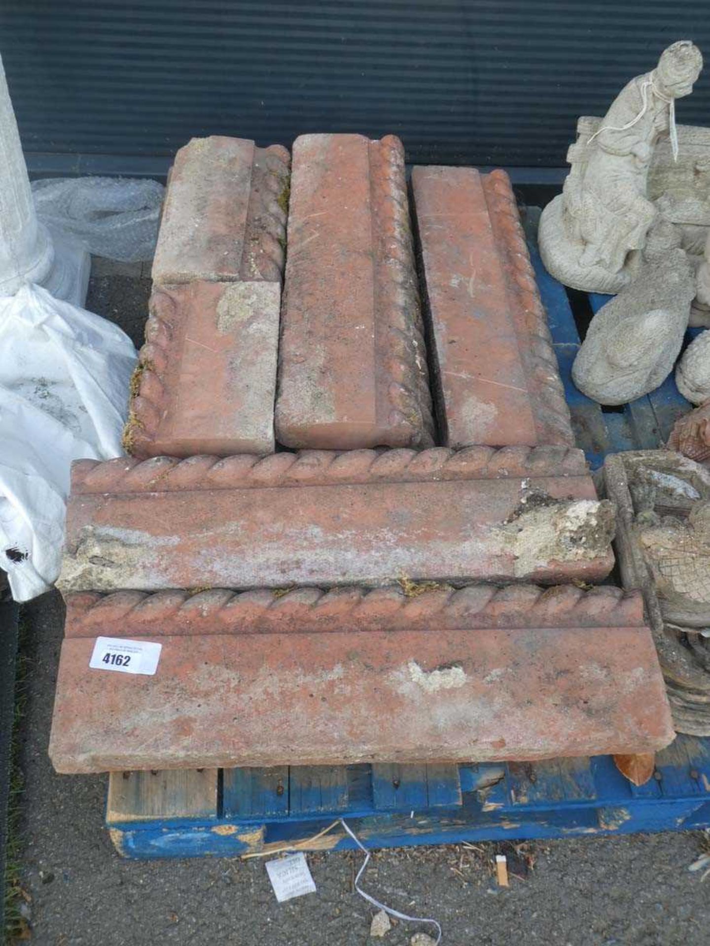 Eight pieces of terracotta coloured edging