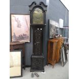 Long cased clock with brass dial and carved panels