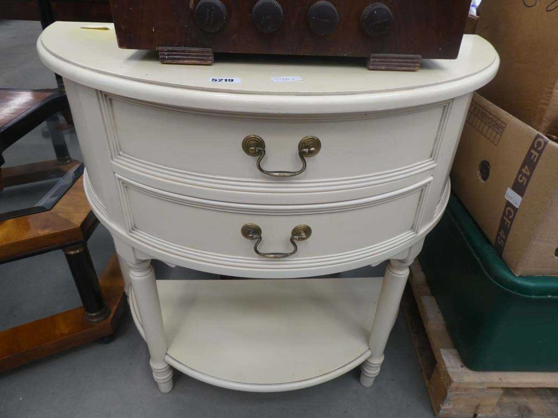 Cream painted demilune cabinet with 2 drawers and shelf under