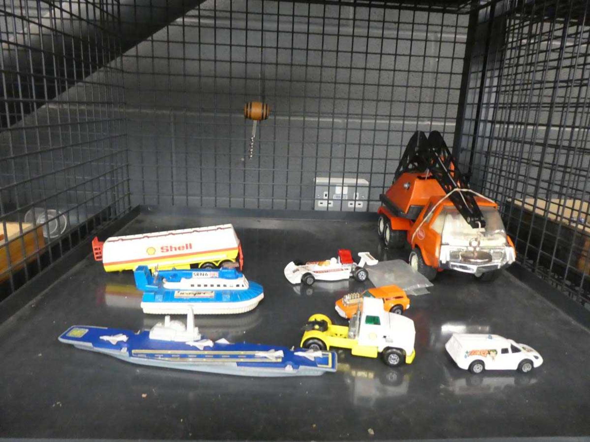 Cage containing Tonka toy and diecast cars and ships