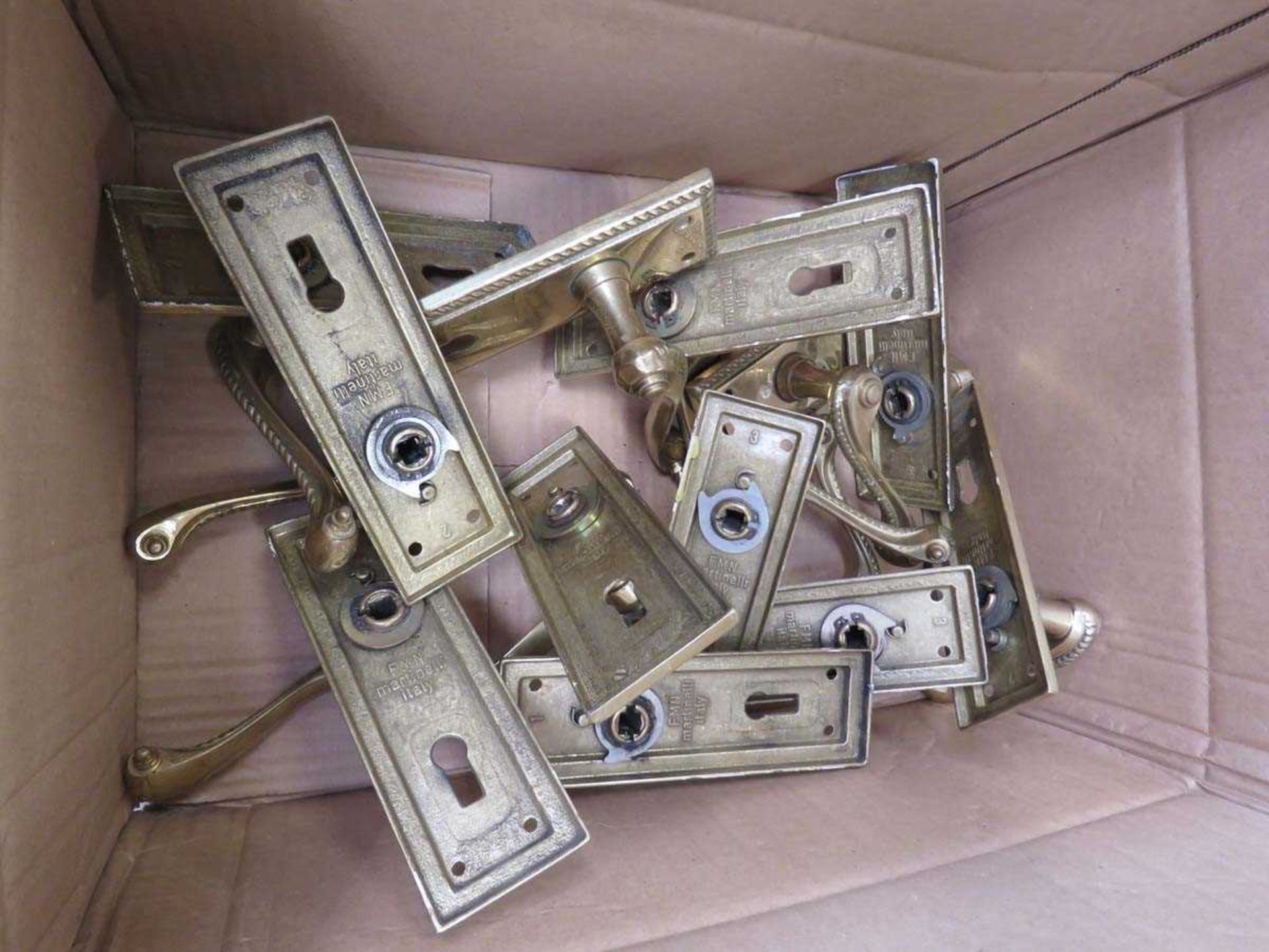 Box containing glass door handles