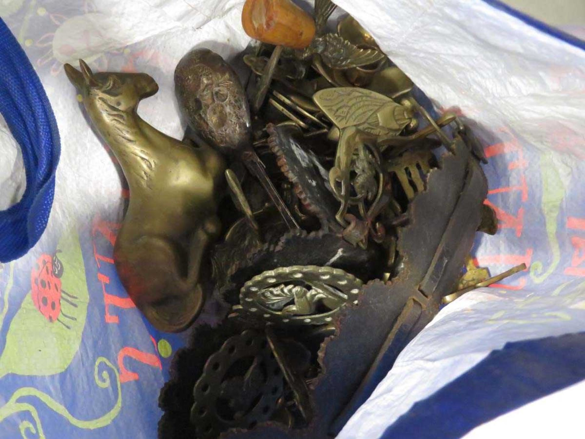 Bag containing horse brasses and ornaments