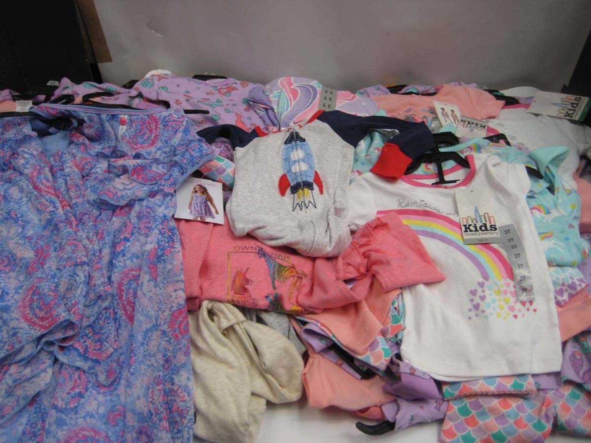 A bag containing a large quantity of Children's Clothing in various sizes.