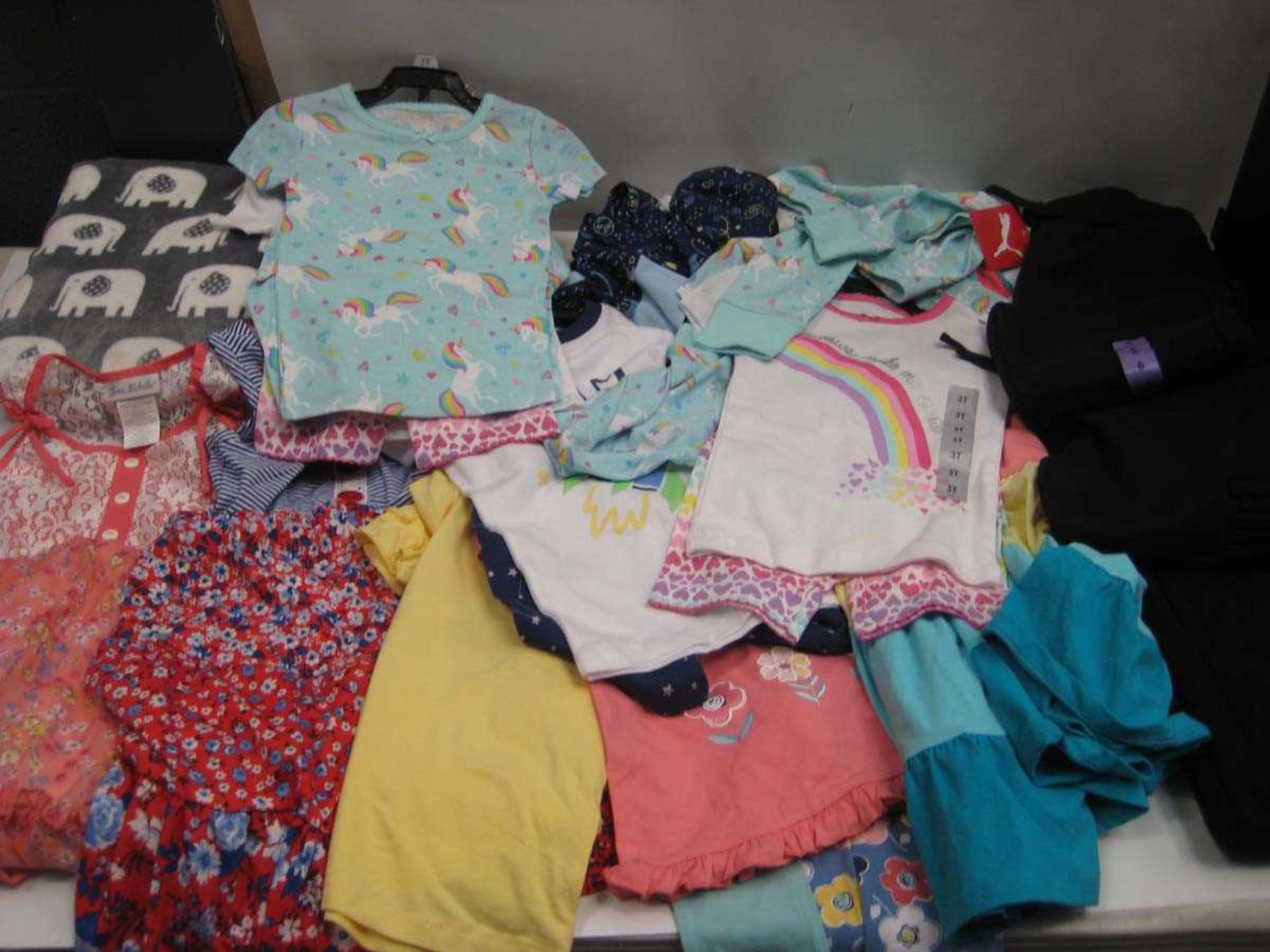 A bag containing Children's Clothing in various sizes, including Elephant Blanket, Puma Joggers.