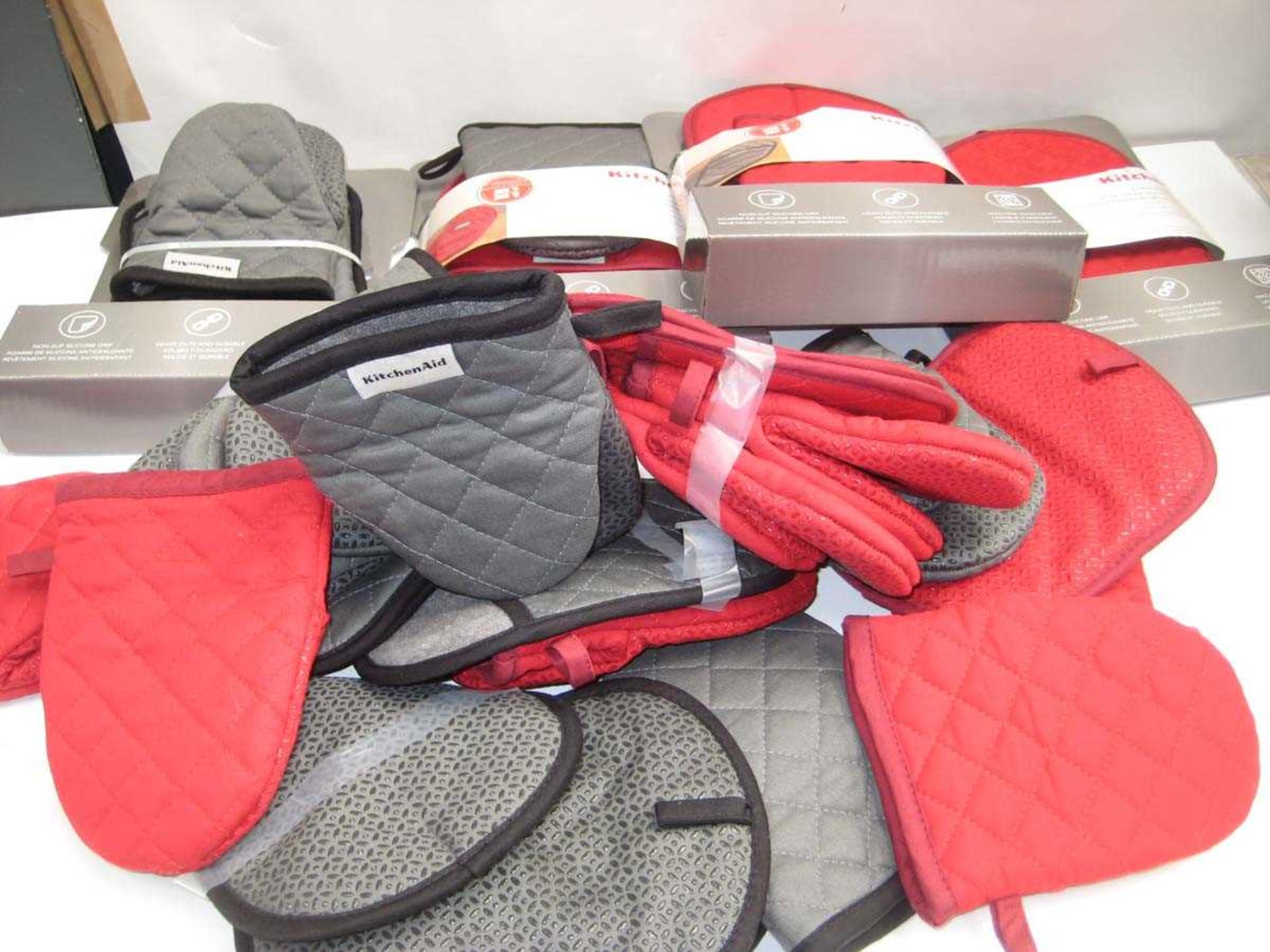 +VAT A bag containing Kitchen Aid Oven Gloves in Red & Grey