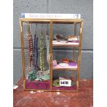 Mini display case with hard stone jewellery and a rocks and mineral reference book