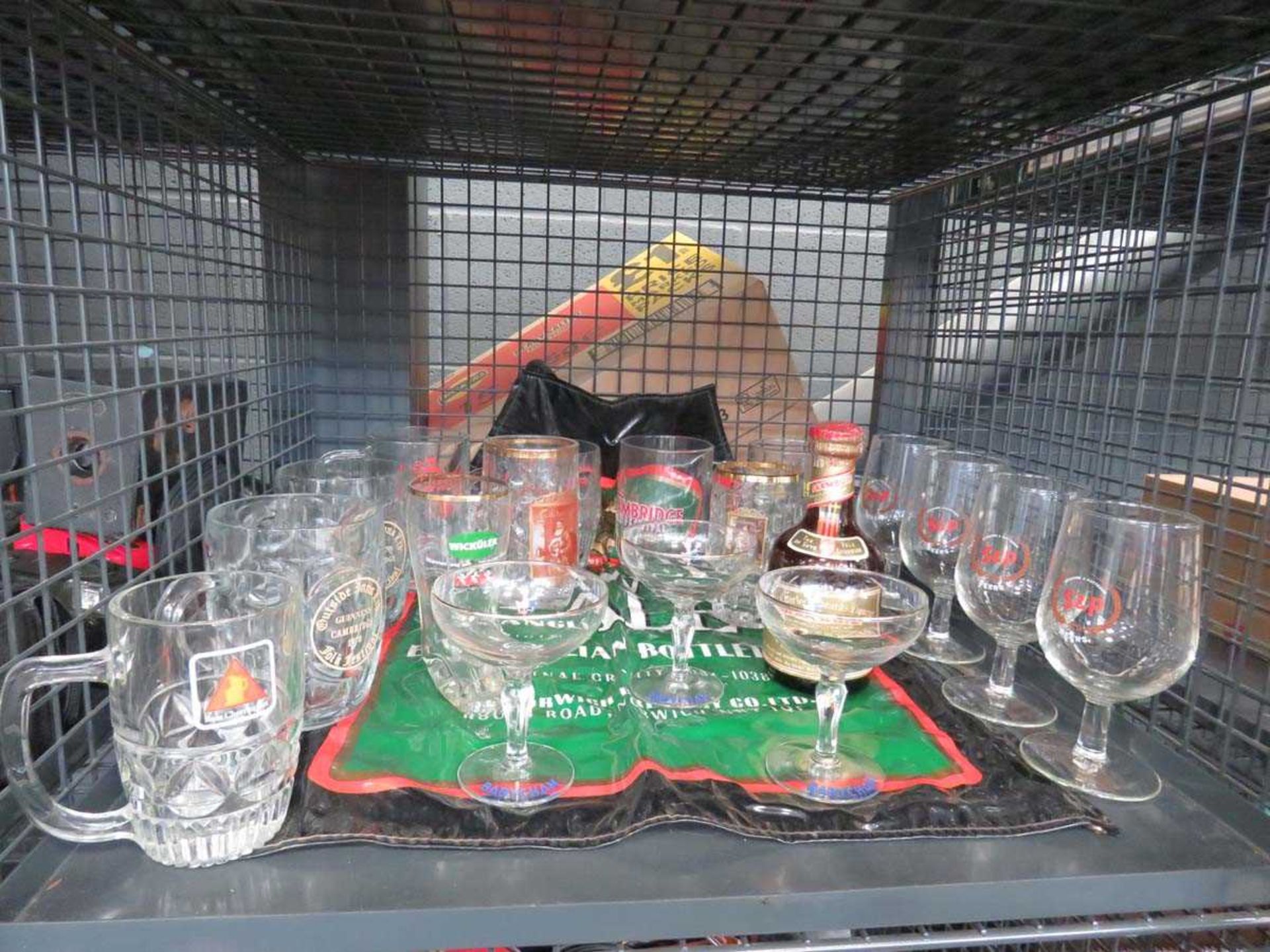 Cage containing 3 Babycham glasses, beer mugs and an apron