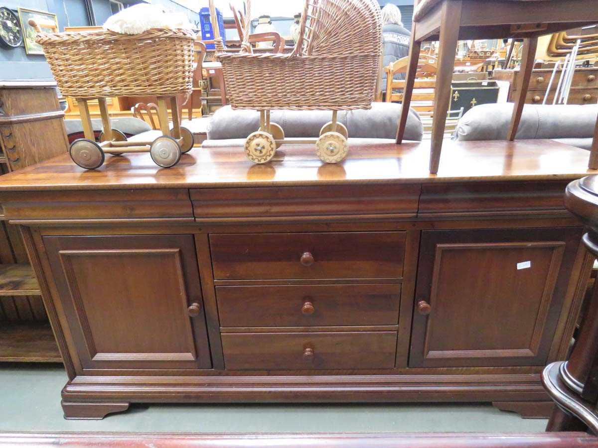 Dark wood sideboard with 3 central drawers and cupboards to the side