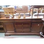 Dark wood sideboard with 3 central drawers and cupboards to the side