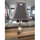 Ornate brass table lamp with black fabric shade