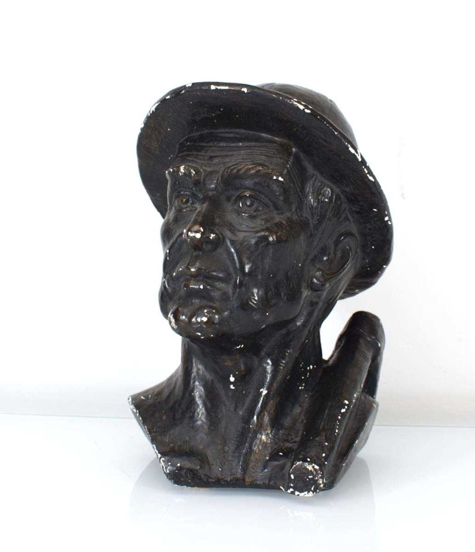 A bronzed plaster figure modelled as a miner, h. 24 cm