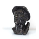 A bronzed plaster figure modelled as a miner, h. 24 cm