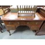 Walnut kneehole desk with brown leather surface