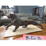 Metal figure of a stretching tiger