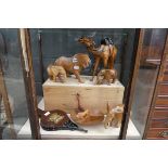 Collection of wooden ornaments including a camel, elephants and a small pair of bellows