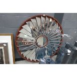 Ornate framed and bevelled circular facetted mirror