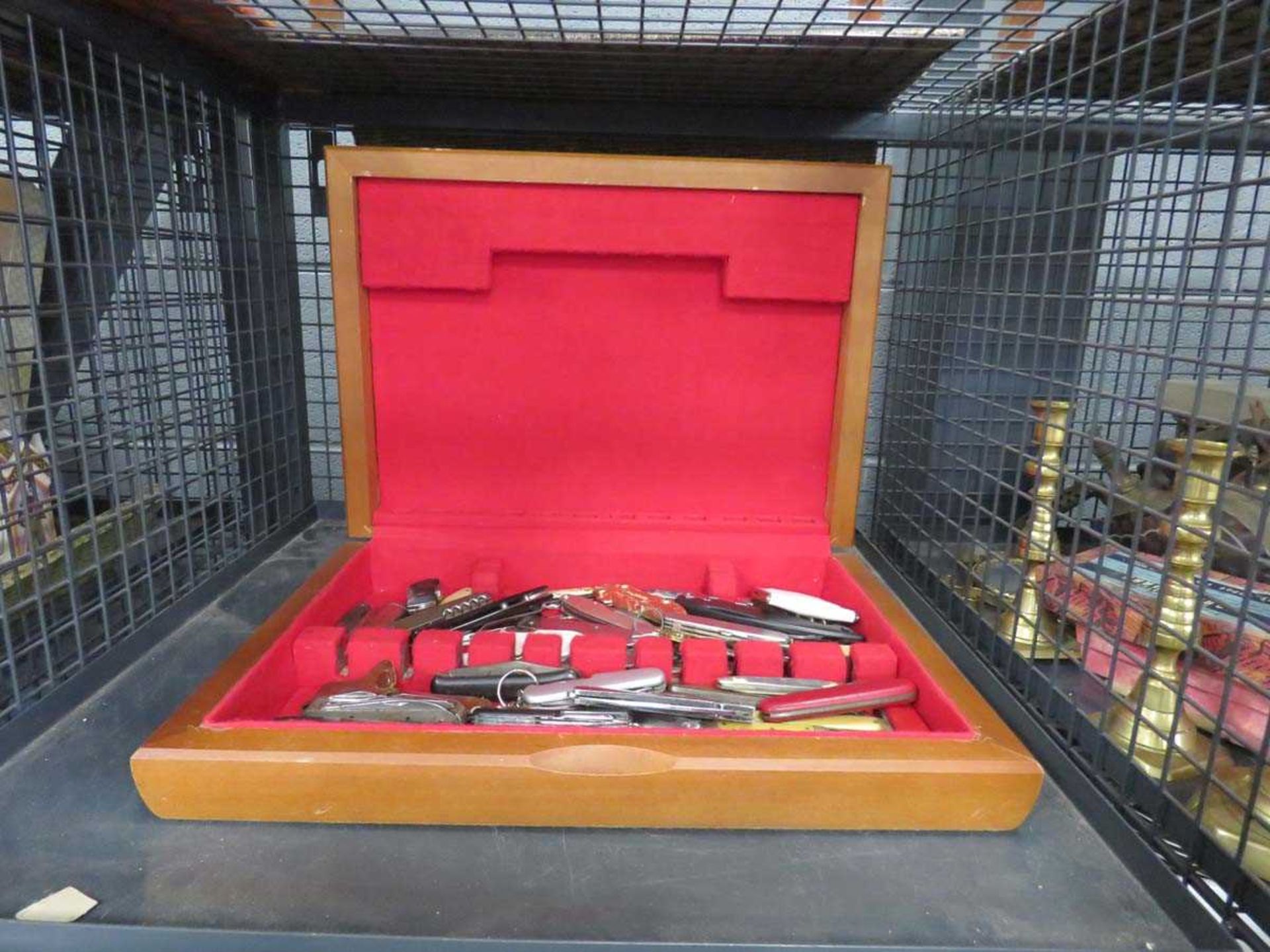 Cage containing a collection of pen knives