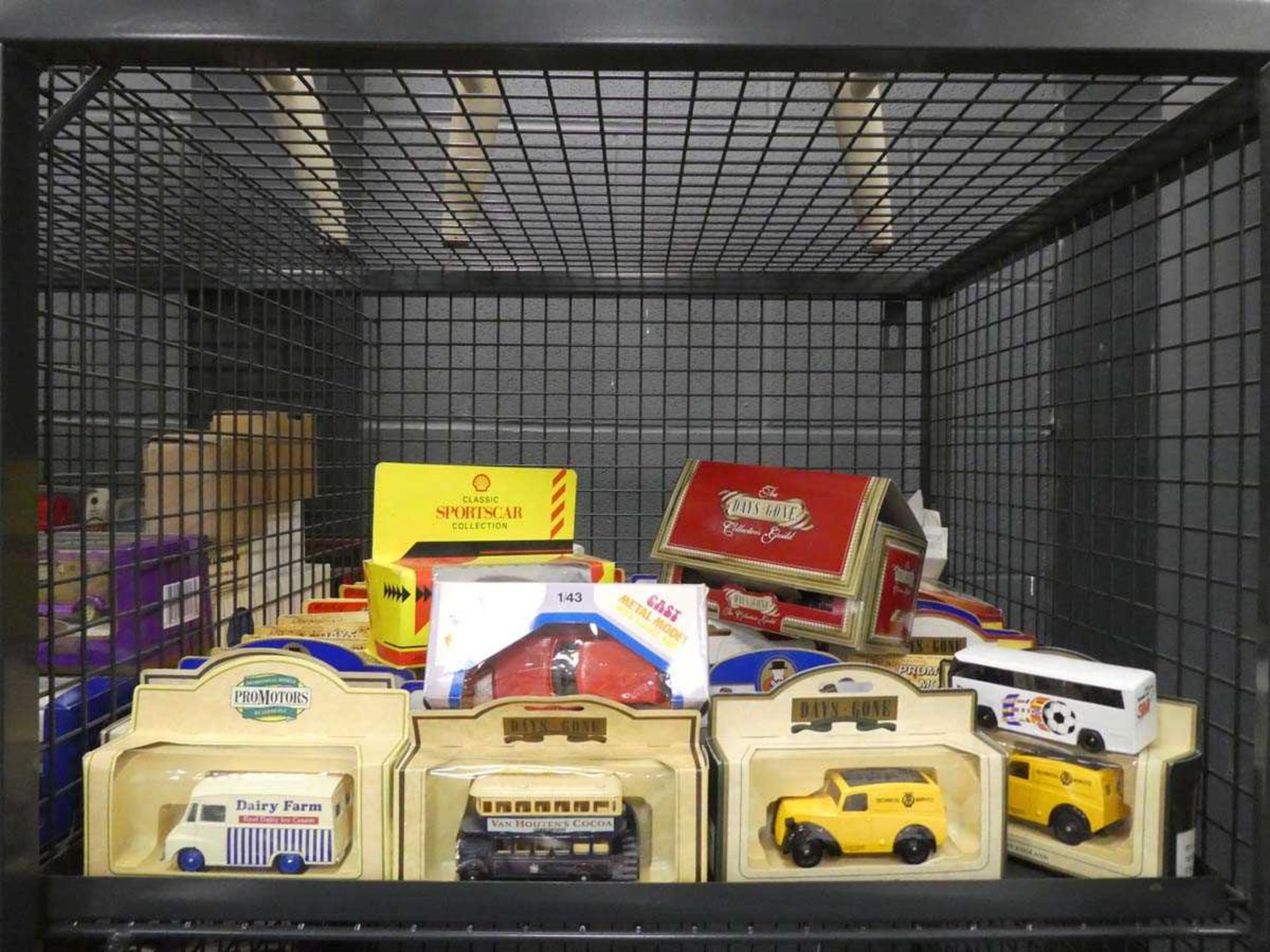 Cage containing boxed Days Gone By models and classic sports car models