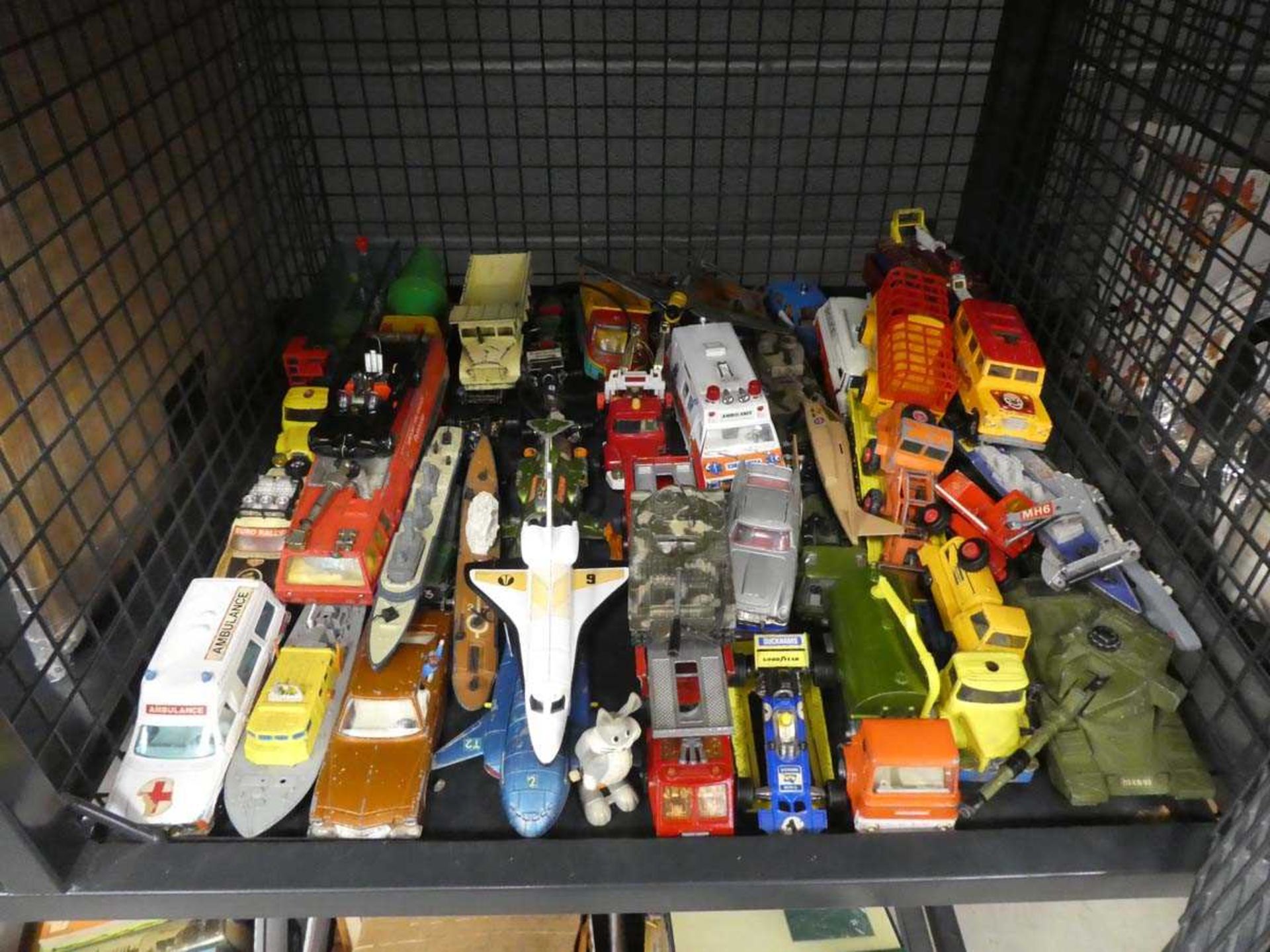 Cage containing a quantity of diecast tanks, lorries, cars and various aeroplanes