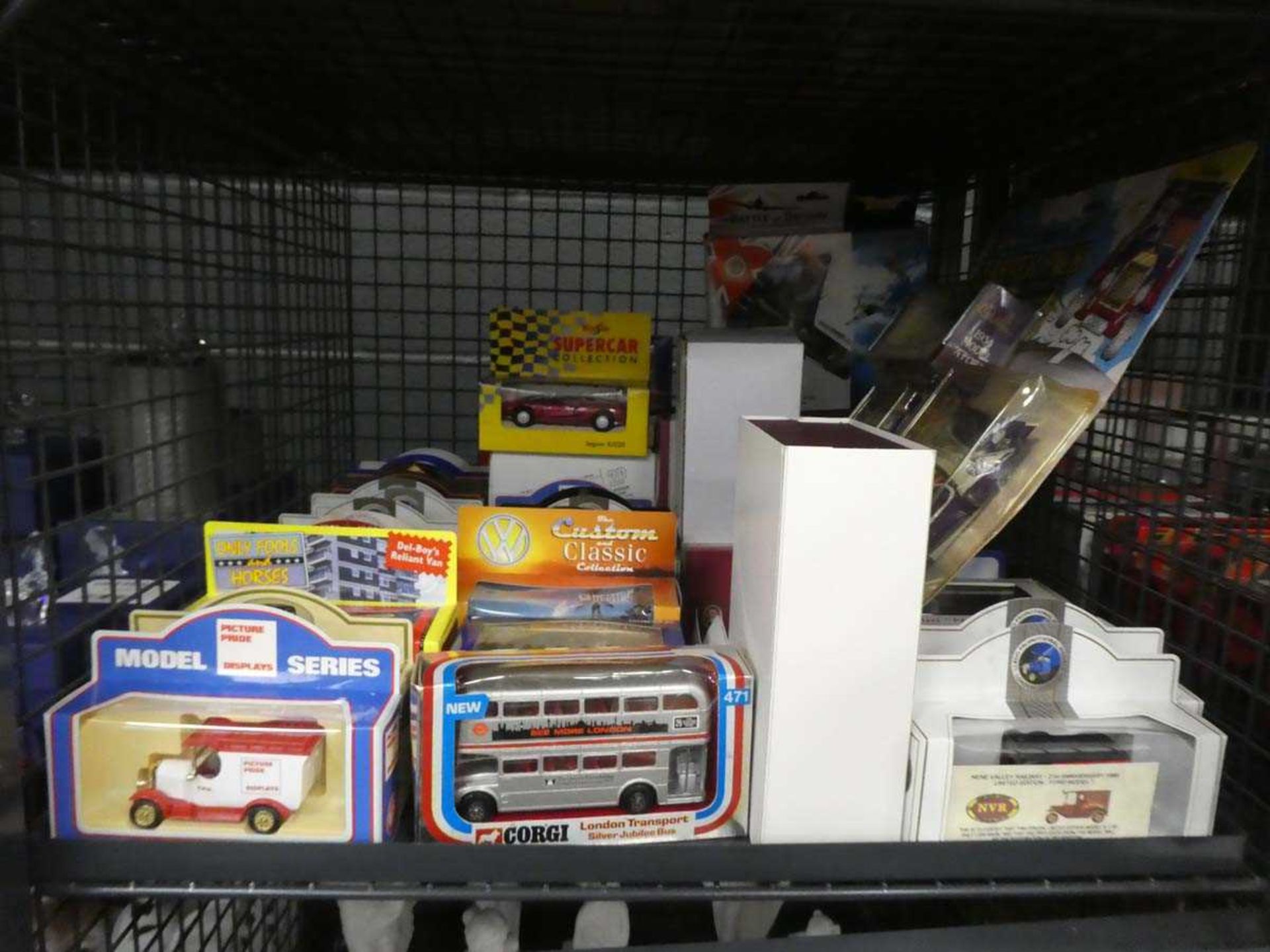 Cage containing Corgi and other boxed diecast cars