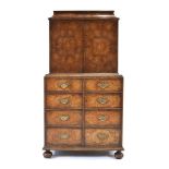 Charles Tozer of London, a 20th century walnut oyster-veneered collectors cabinet, the lift-lid over