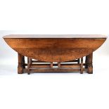 An 18th century style oak gateleg 'wake' table, 213 x 148 cm