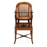 A Victorian mahogany and bergere child's highchair on stand with a removeable rail and adjustable