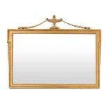 A 19th century giltwood wall mirror with a partially castellated frame, surmounted by an urn and