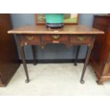 A Georgian walnut lowboy, the associated surface over three frieze drawers, a shaped apron and