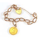 A 9ct yellow gold curblink bracelet with heart shaped padlock clasp suspending a Victorian shield