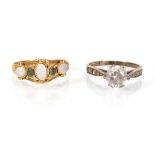 An early 20th century yellow metal ring set opal and emerald and a 9ct yellow gold ring set paste,