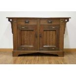A Commercial Arts & Crafts oak sideboard, lacking superstructure, with two drawers and two doors