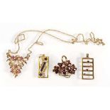 A 9ct yellow gold pendant in the form of a basket of flowers set garnet, two further 9ct pendants of