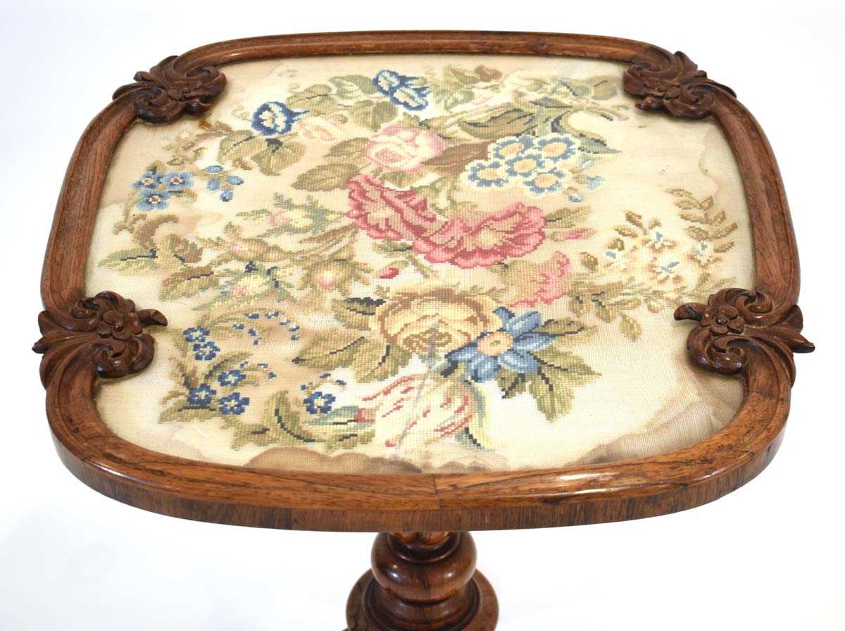 A 19th century rosewood occasional table with an embroidered surface on a turned column and three - Image 2 of 3