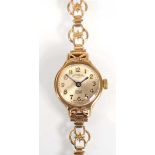 A ladies 9ct yellow gold wristwatch by Rotary, the circular silvered dial with gold Arabic