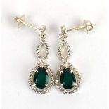 A pair of 14ct white gold ear pendants, each set a pear cut emerald and small diamonds, l. 3 cm,