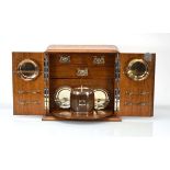 A Victorian oak and crossbanded smoker's cabinet, the fitted interior with a revolving compartment