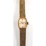 A 9ct yellow gold ladies wristwatch by Tudor (Rolex), the tonneau dial with gold coloured baton