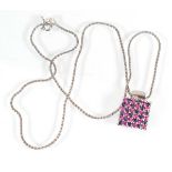 An 18ct white gold necklace suspending a square pendant set sapphires and pink stones, 8.9