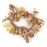 A 9ct yellow gold curblink bracelet with heart shaped padlock clasp suspending twenty-four charms