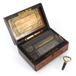 A late 19th century miniature music box playing on two airs, within a rosewood and pewter lined